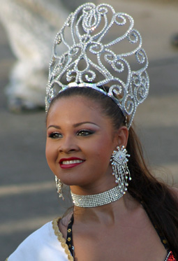 Barranquilla Carnival Queen in Silver Carnival queen wearing an ornate silver crown, matching earrings, and a rhinestone choker