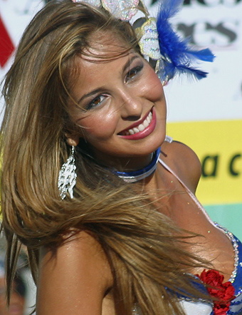 Smiling Barranquilla Carnival Beauty Close-up of a joyful Colombian woman with flowing hair, glittering earrings, and a festive red, white, and blue costume, smiling brightly during the Barranquilla Carnival.