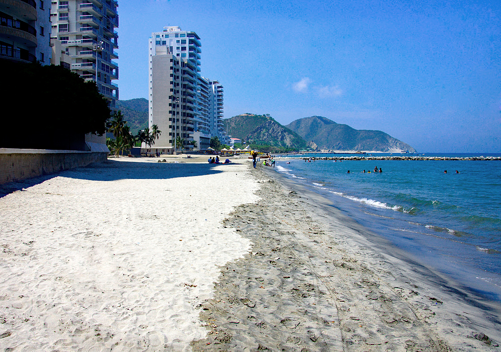 Santa Marta beach blue water and sky with mountains in the background during wet season