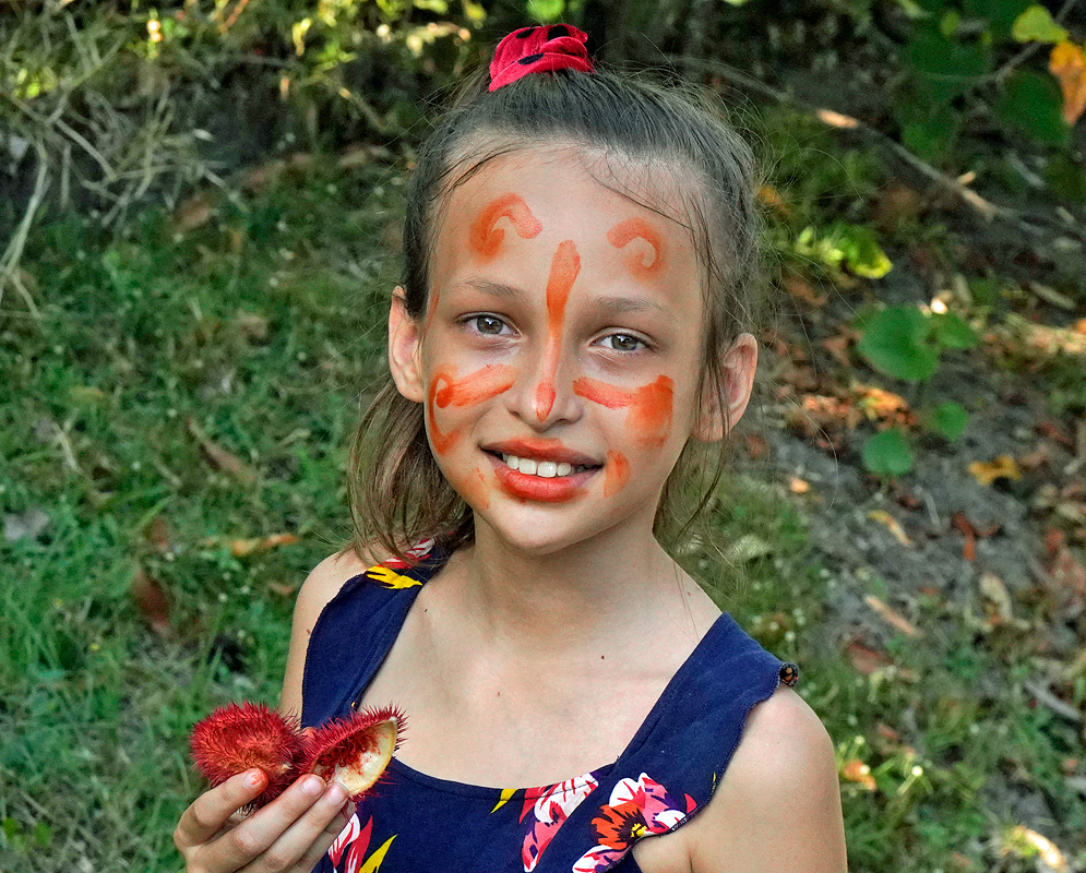 A pretty girl with Bixa orellana dye on her face