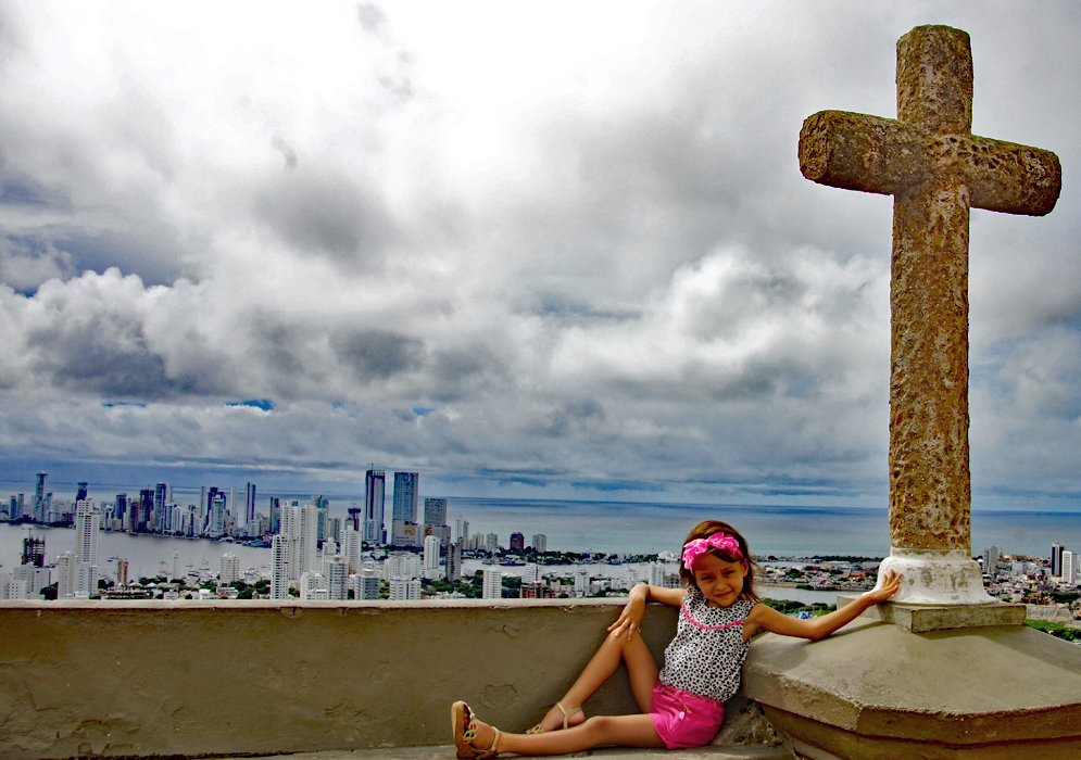 Five year old child next to a cross overlooking Bocagrande Cartagena