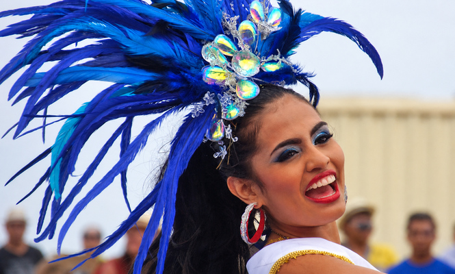 Barranquilla Dancer in Blue Feathers Smiling Carnival dancer wearing a jeweled blue feather headdress during the Barranquilla parade