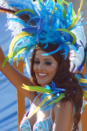 Dark Carnival woman in blue feather costume