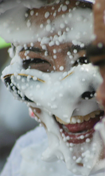 A man's face covered in spray foam
