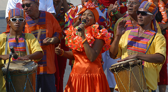 Colorful Barranquilla Carnival music band with singers and drummers performing in traditional costumes
