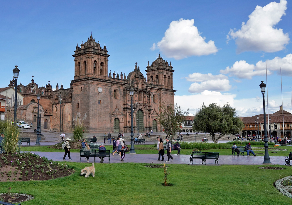 Cathedral Basilica of the Assumption, Cusco The Cathedral Basilica of the Assumption in Cusco, Peru, viewed from a lush green plaza with visitors and a dog