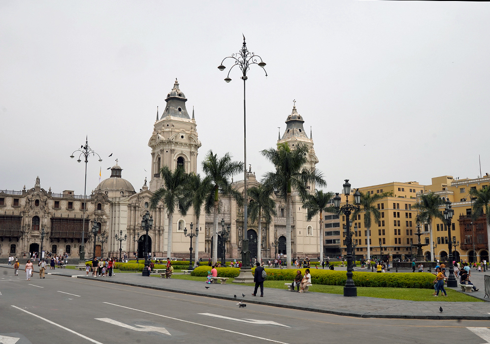 Cathedral of Lima at Plaza Mayor Front view of the Cathedral of Lima in Plaza Mayor with people walking and palm trees in the foreground