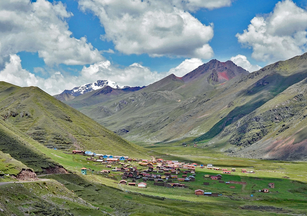 Chillca Village in Andes A small Andean village with colorful rooftops nestled in a green alpine valley surrounded by high peaks in Peru