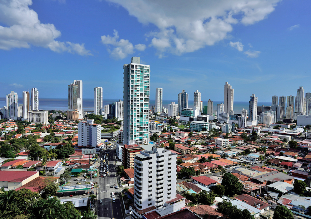 Panama City Skyline Aerial view of modern high-rise buildings and red-roofed residential neighborhoods stretching toward the Pacific Ocean in Panama City