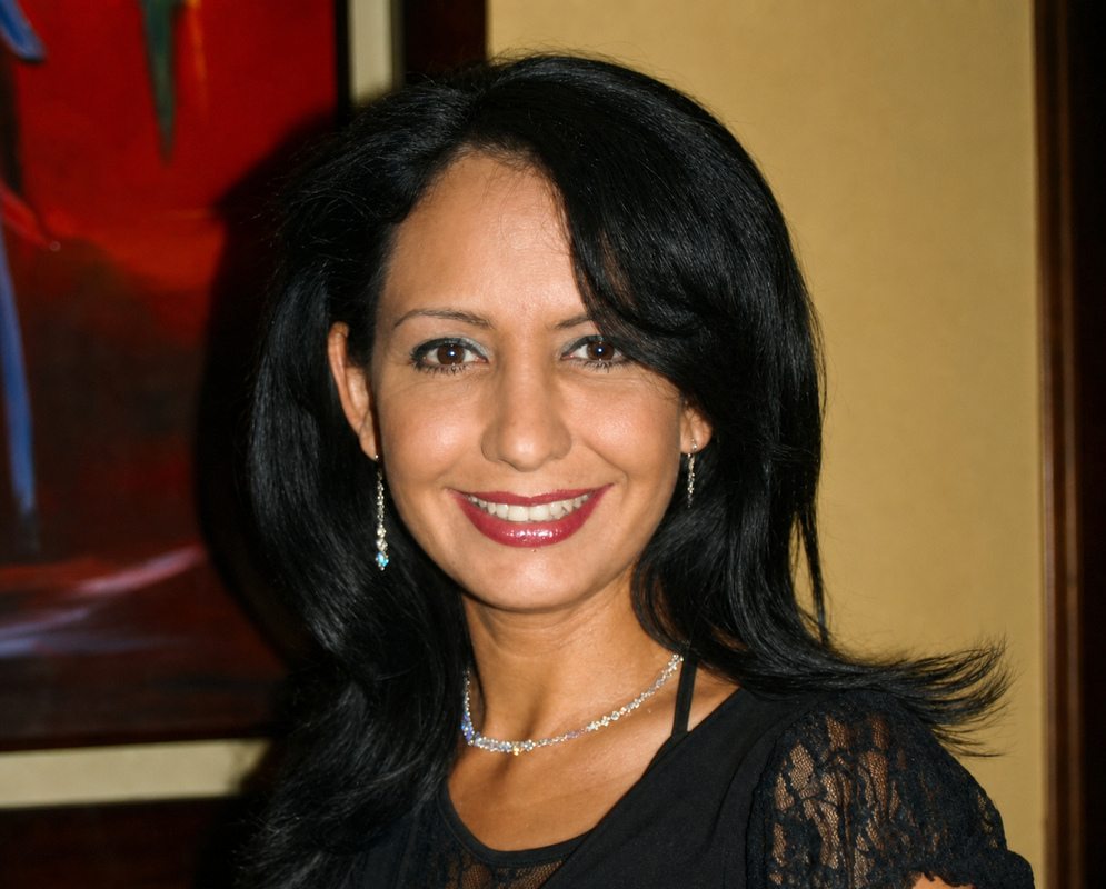 Colombian Woman in Black Lace Smiling Colombian woman with shoulder-length black hair wearing a black lace top and silver jewelry