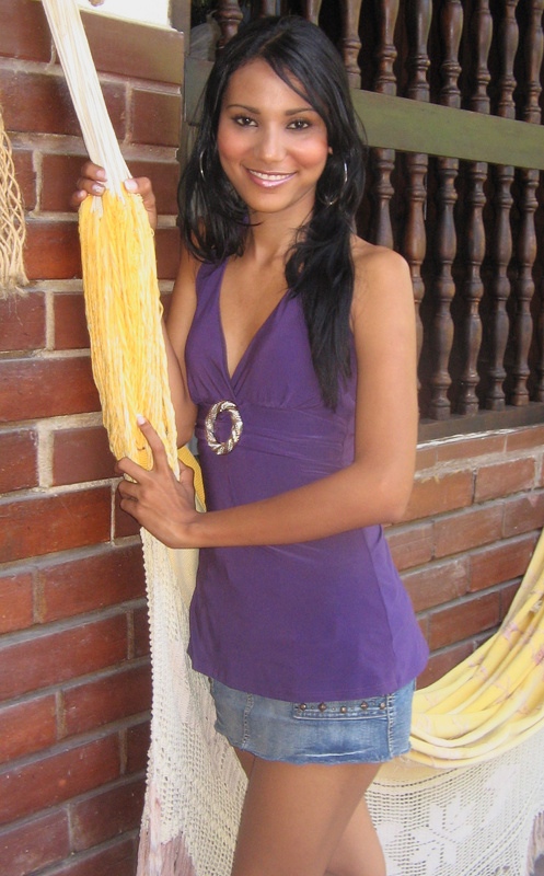 Colombian Woman Purple Top Hammock Colombian woman wearing a purple top near a hammock