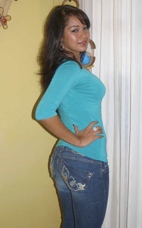 Colombian Woman Turquoise Shirt Side Pose Colombian woman wearing a turquoise shirt in a side pose