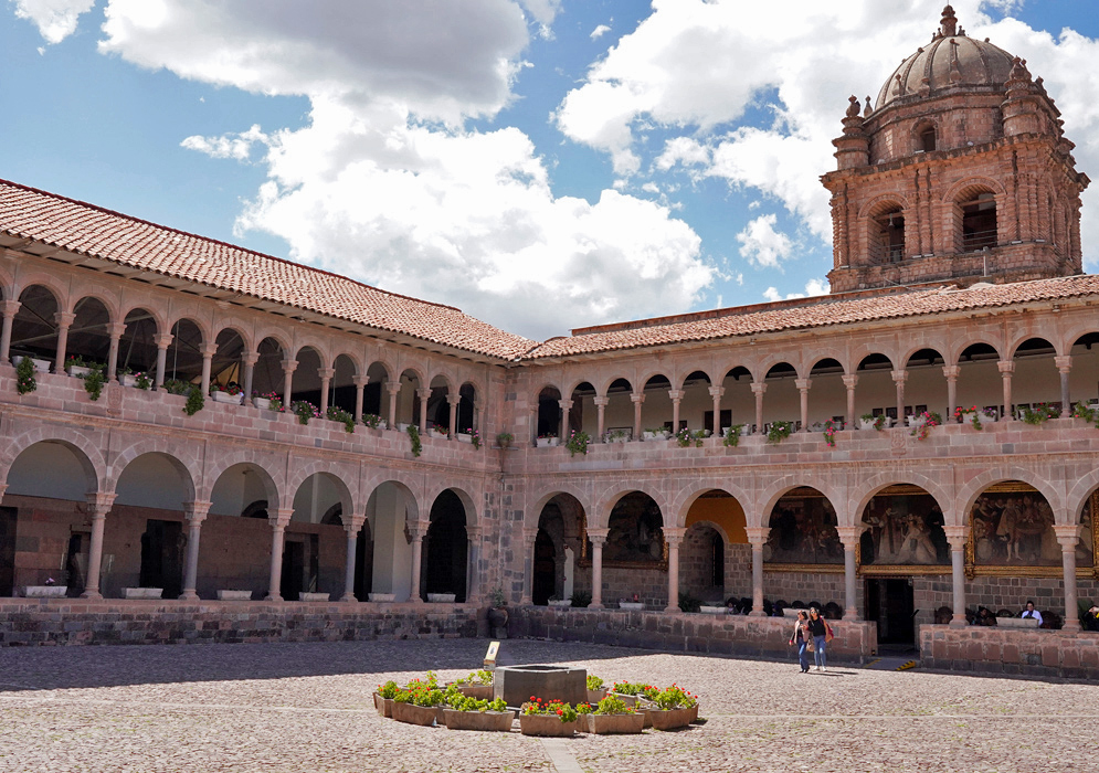 Santo Domingo Convent Courtyard Courtyard of the Convent of Santo Domingo in Cusco with colonial arches, flower planters, and a tall dome tower rising into the sky