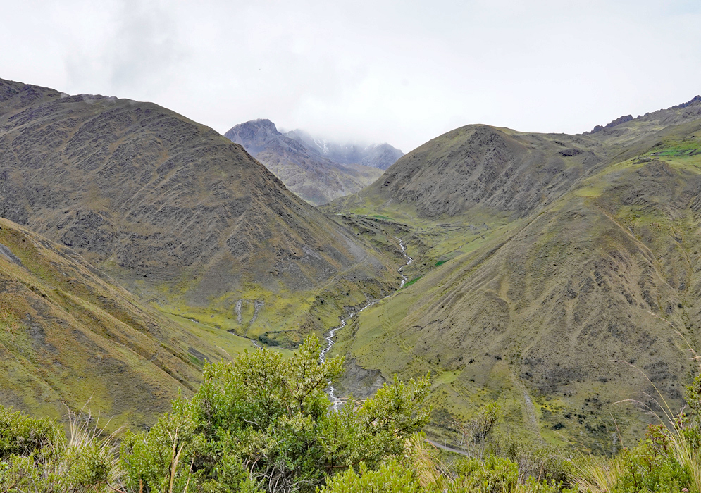 Cordillera Vilcabamba Peru Landscape Let me know if you'd like a Spanish version or matching SEO phrases for a page. Ask ChatGPT You said: write one or two paragraphs about cordillera-vilcabamba ChatGPT said: The Cordillera Vilcabamba is a remote and rugged mountain range in southern Peru, northwest of Cusco, known for its dramatic peaks, deep valleys, and historical significance. This chain forms part of the greater Andes and is best known as the refuge of the last Inca resistance after the Spanish conquest. It was here, hidden in the forested canyons and isolated ridges, that the Incas established the lost city of Vilcabamba, a final stronghold before their defeat in the late 1500s. Geographically, the Cordillera Vilcabamba is characterized by steep rock formations, high-altitude grasslands, and sharp ridges draped in cloud forest vegetation. The range includes peaks over 5,000 meters and is less visited than the Sacred Valley or Ausangate area, making it ideal for adventurous trekking and remote exploration. The region supports small Andean communities that still rely on traditional farming and herding, and its complex topography shelters a rich diversity of flora and fauna, many adapted to the transitional zone between high Andes and Amazon Serene mountain valley in the Cordillera Vilcabamba with a winding stream cutting through rounded grassy hills beneath a misty horizon