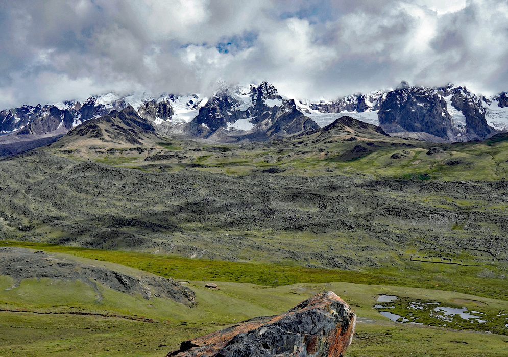 Cordillera Vilcanota Peru Expansive view of the Cordillera Vilcanota in Peru, where snowy peaks tower above vast green valleys and layered mountain ridges