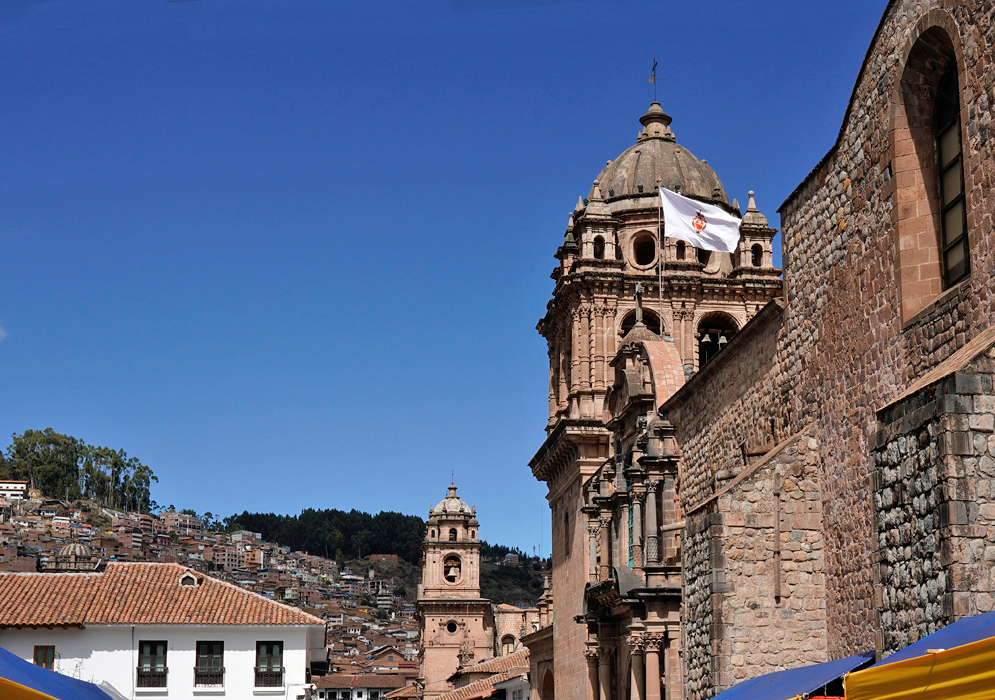 Colonial churches in Cusco, Peru Historic churches in Cusco, Peru with baroque architecture and stone towers under a deep blue sky