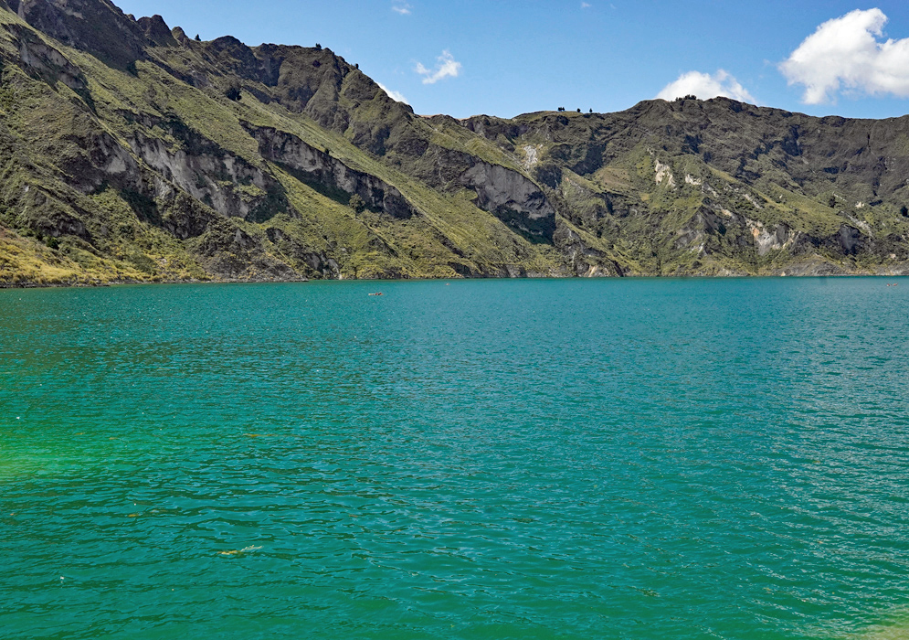 Quilotoa Lake Crater Turquoise water of Quilotoa Lake surrounded by steep volcanic cliffs under a clear sky in Ecuador’s Andes Mountains