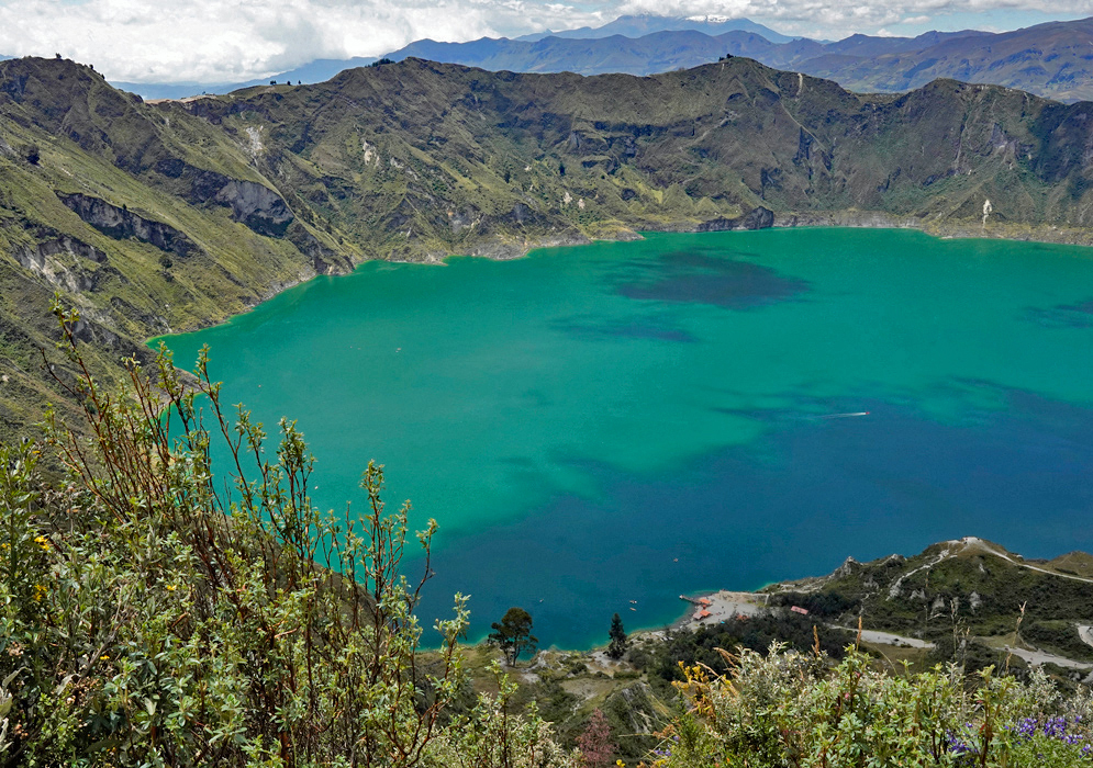 Quilotoa Lake Overview Aerial view of the emerald-green Quilotoa Lake nestled within a volcanic caldera, encircled by rugged highland peaks