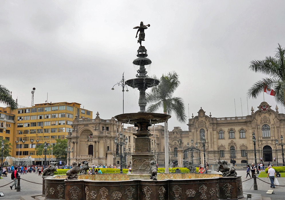 Historic fountain at Plaza Mayor, Lima Ornate bronze fountain at Plaza Mayor in Lima surrounded by colonial architecture and palm trees