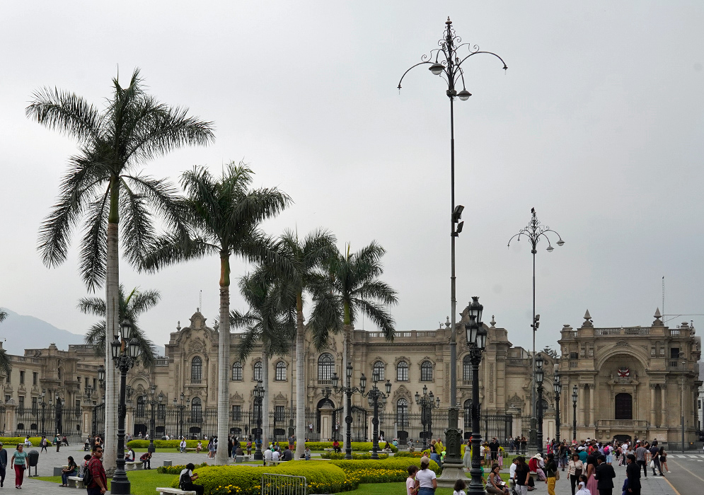 Government Palace of Peru The Government Palace of Peru as seen from Plaza Mayor, with manicured gardens, historic lamp posts, and visitors enjoying the scene