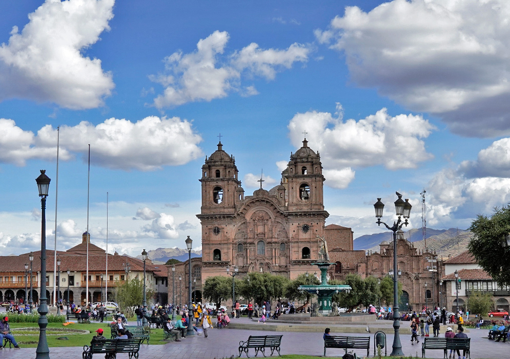 Cusco Society of Jesus Church Close-up of the detailed stone facade and twin bell towers of the Church of the Society of Jesus in Cusco, set against a cloudy sky