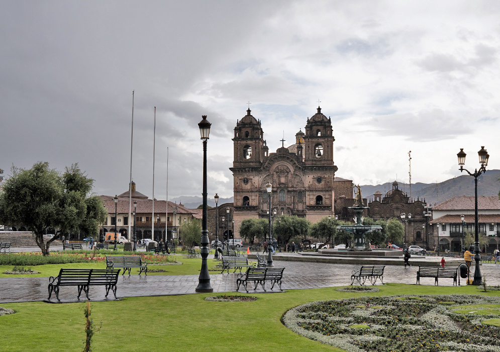 Plaza de Armas and Church of La Compañía in the Rain Rain-soaked Plaza de Armas in Cusco with people walking in front of La Compañía de Jesús church