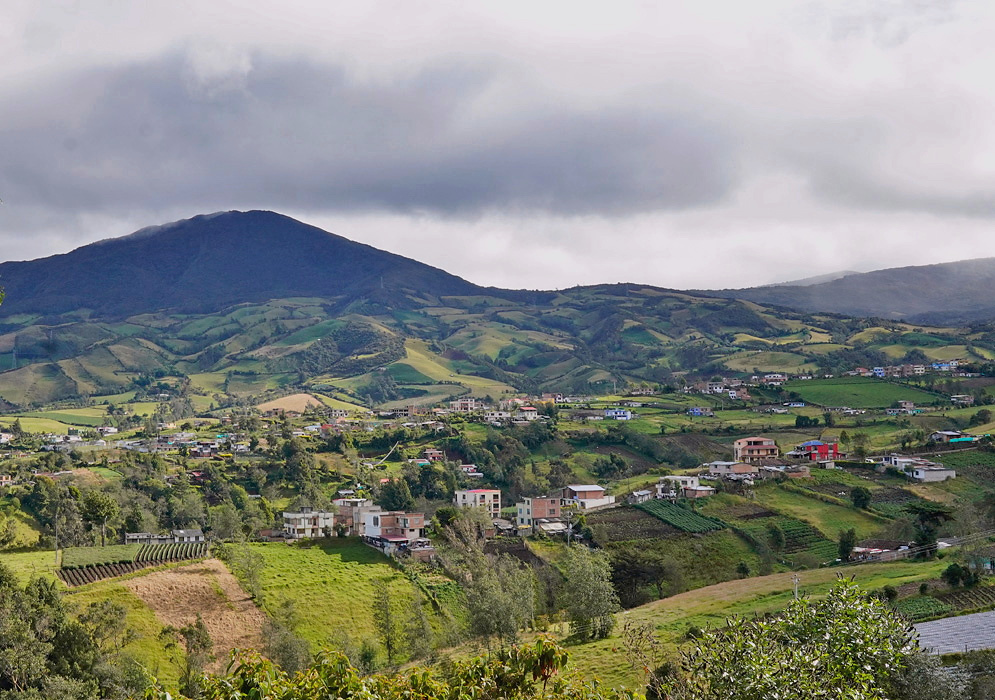 A highland lagoon lies between green mountain slopes in Nariño