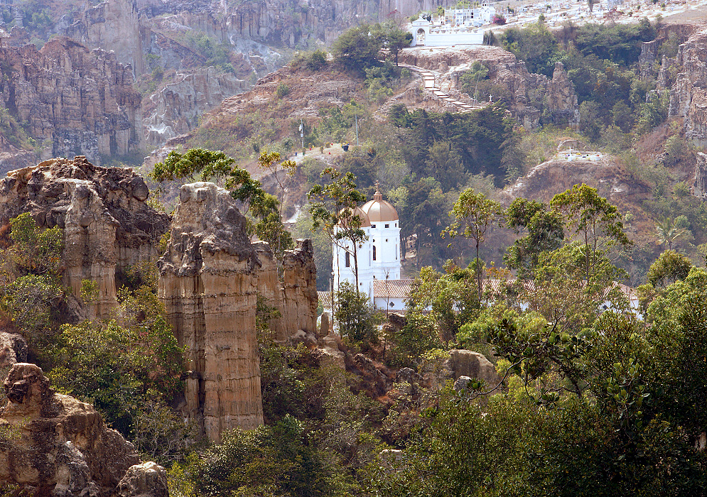 church tower surrounded by rock cliffs 