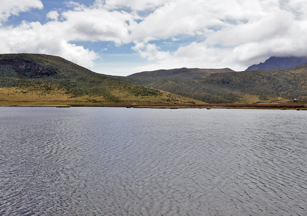 Limpiopungo Lagoon in Cotopaxi Park The still waters of Limpiopungo Lagoon stretch beneath rolling hills inside Cotopaxi National Park