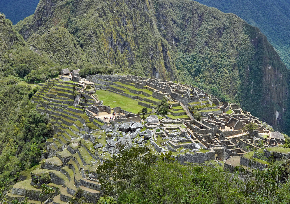 Machu Picchu Inca Multi-tiered agricultural terraces and intricate stone structures of Machu Picchu set against lush mountain slopes