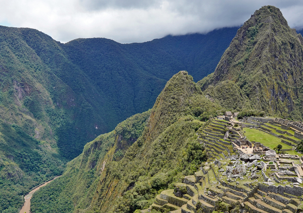 Machu Picchu Ruins Peru Elevated view of the ancient Inca citadel of Machu Picchu with steep green mountains and a winding river below