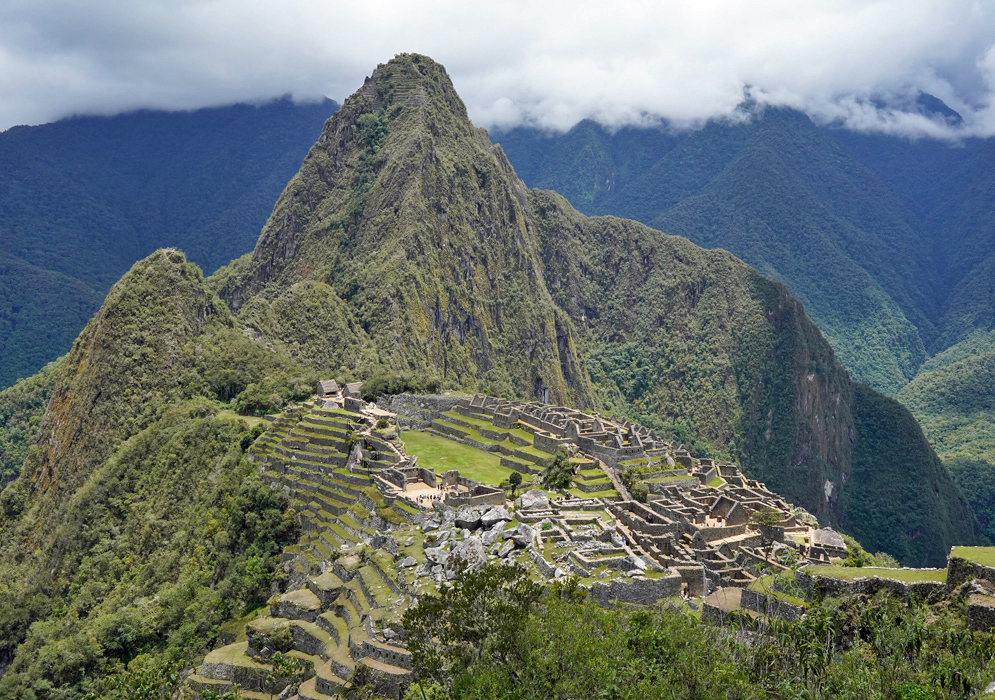 Machu Picchu Panoramic shot of the full Machu Picchu archaeological complex framed by sharp ridges and thick cloud forest