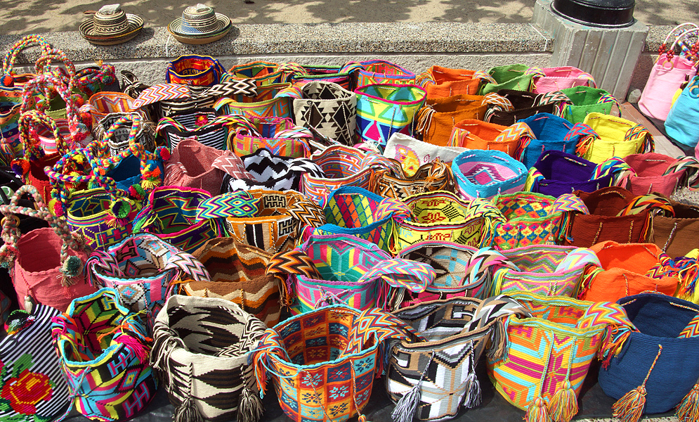 Colorful mochilas displayed on a sidewalk