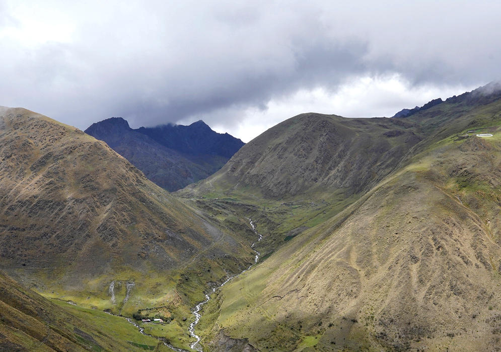 Cordillera vilcabamba River Canyon A steep Andean canyon in the Cordillera Vilcabamba with a winding river at the bottom, surrounded by rugged hills and misty mountain ridges