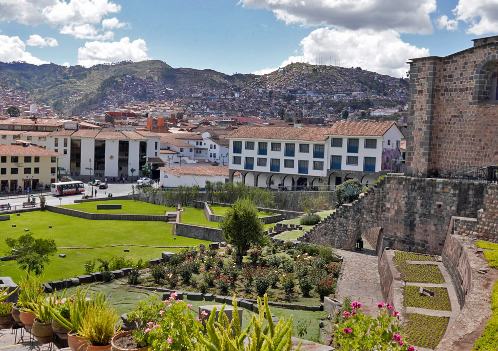Cusco Peru Landscape Gardens and stone terraces next to the Convent of Santo Domingo in Cusco, with modern buildings and hills rising in the background