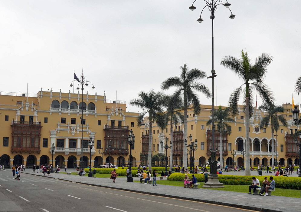 Plaza Mayor de Lima Peru View of Lima’s Plaza Mayor with palm trees, lush gardens, and the ornate Government Palace in the background