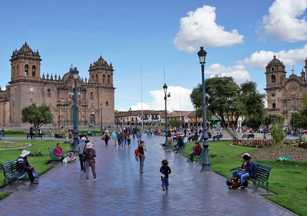 Plaza de Armas Cusco Busy scene in Cusco’s Plaza de Armas with the Cathedral Basilica on one side, gardens, benches, and people enjoying the public space
