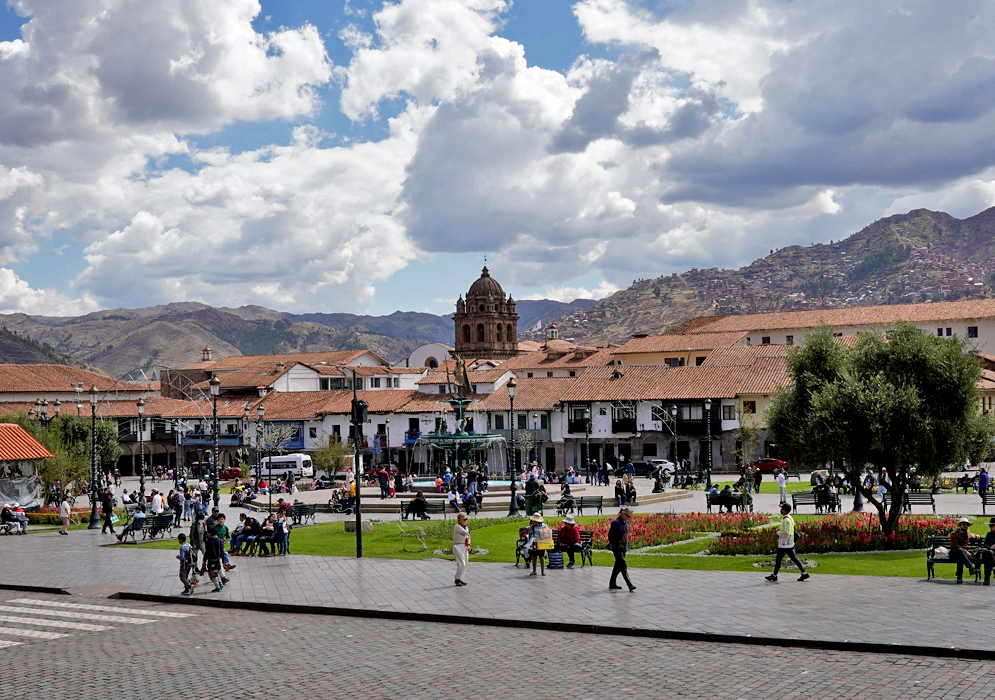 Crowd in Plaza de Armas, Cusco Busy day at Plaza de Armas in Cusco, Peru, with colonial rooftops, people walking, and surrounding mountains