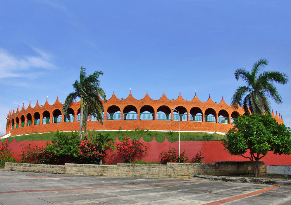 A red and rust-orange stadium used for bullfights