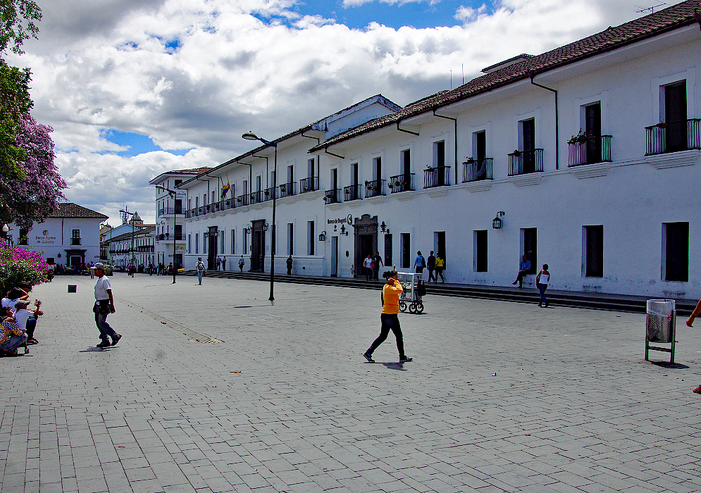 A block of white buildings  near the plaza