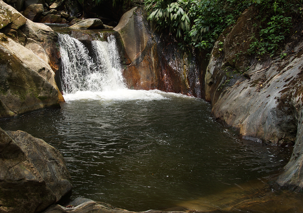 Deep swimming hole with small waterfall