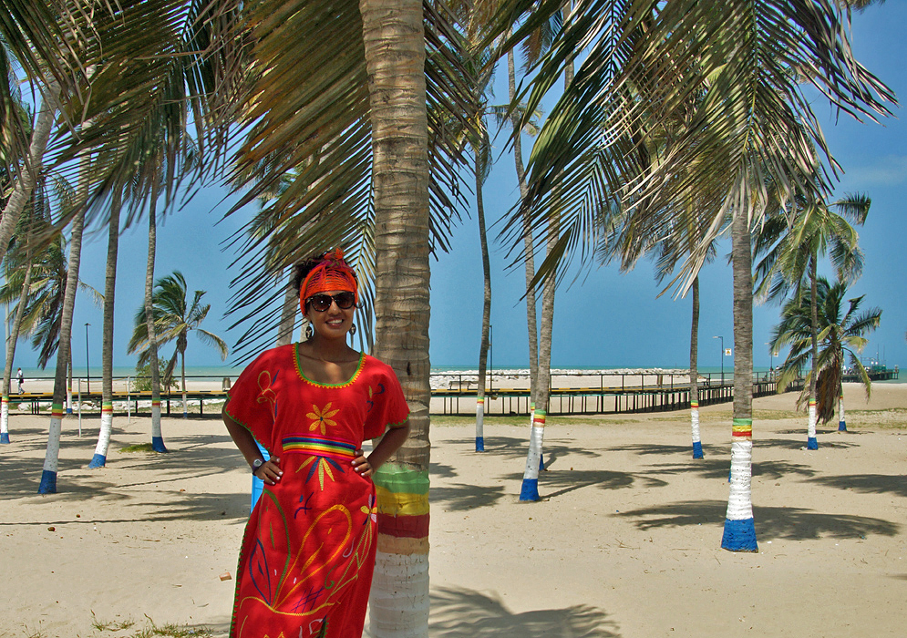 Woman in Wayuu outfit on the beach in front of Riohacha pier