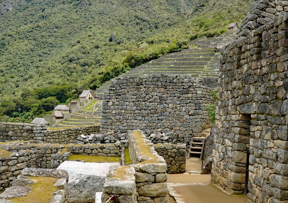 Inca Ruins at Machu Picchu View of ancient Inca stone buildings and agricultural terraces at the ruins of Machu Picchu, nestled in the Andes Mountains