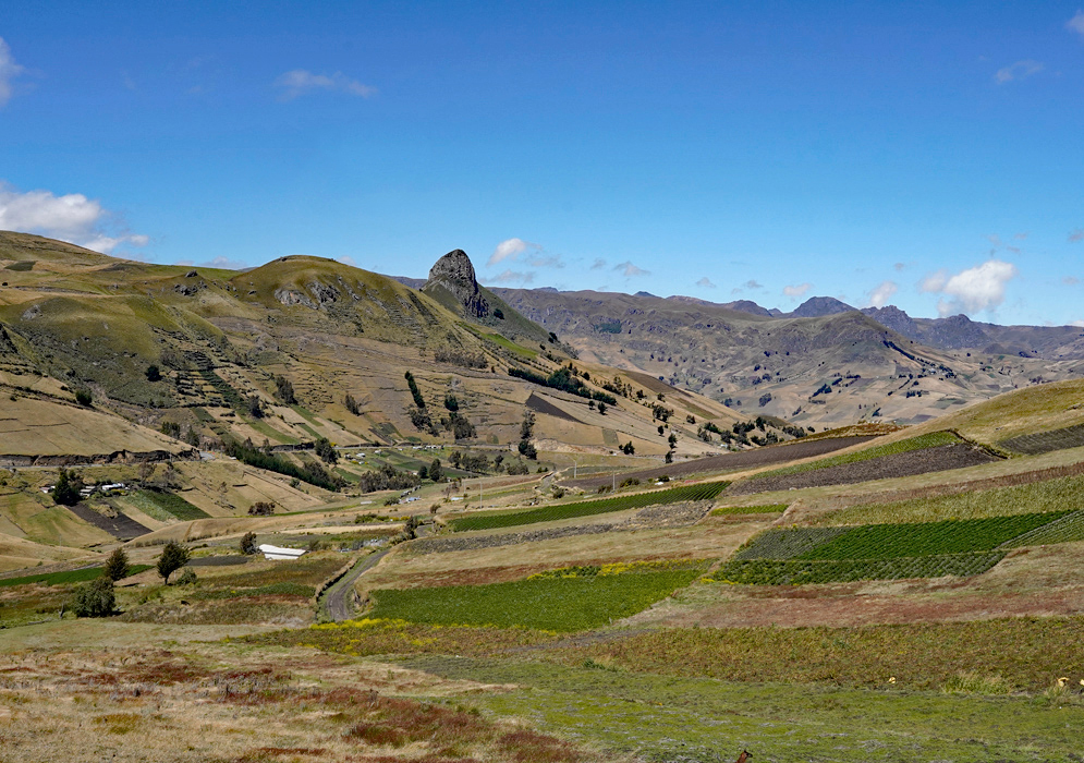 Terraced Fields In Ecuadorian Parish Isolated ridge with green upper slopes stands above terraced agricultural fields in a remote Ecuadorian parish