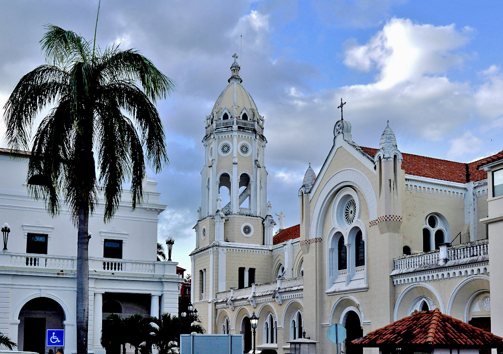 San Francisco de Asís Church Panama White colonial-style San Francisco de Asís Church with red-tile roof and ornate bell tower under a blue sky with scattered clouds in Panama City