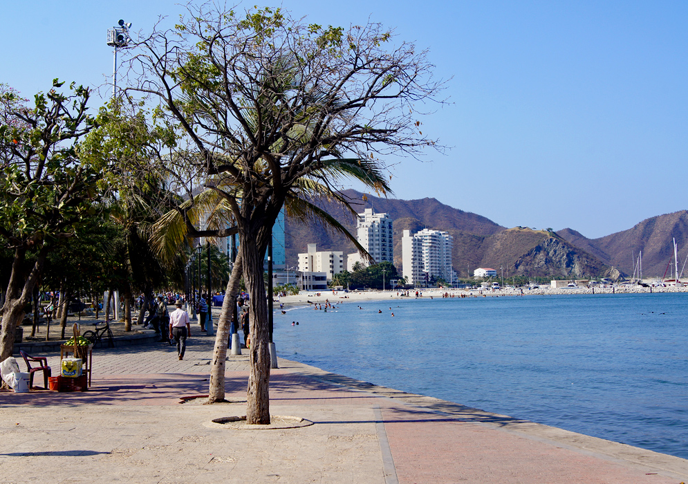 Walkway, white sands and boat harbor in Santa Marta, Colombia