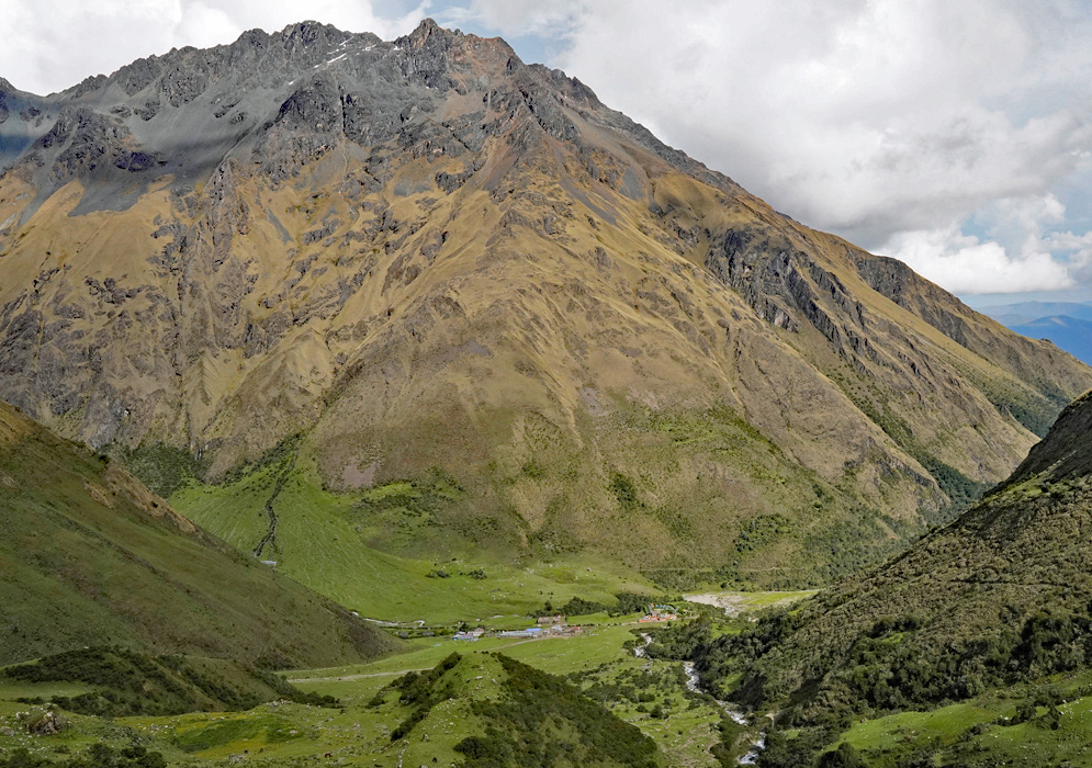Soraypampa Peru Remote mountain settlement of Soraypampa at the base of steep Andean cliffs, surrounded by grassy valleys and a winding river