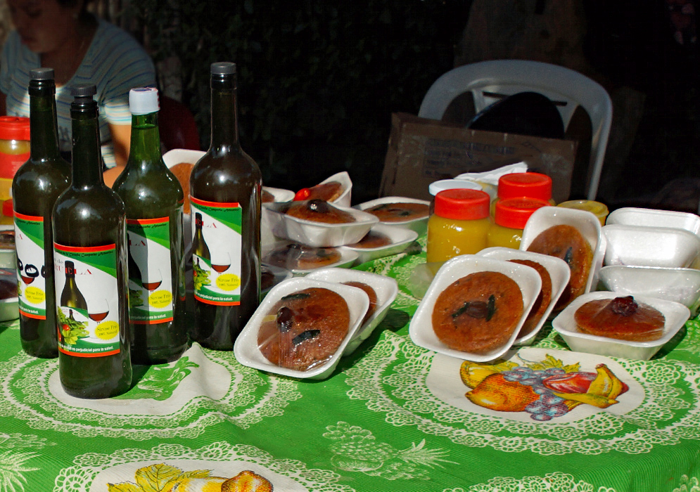 A table displaying Spondias purpurea wine, cakes and marmalade 