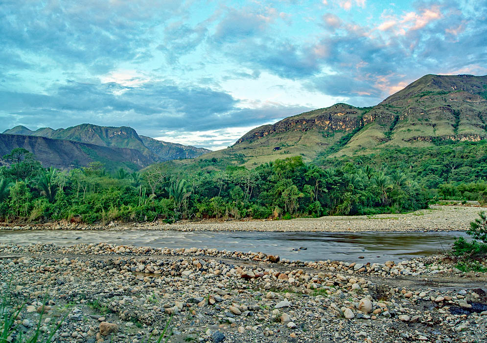 Shallow river with stony shore flowing north from Sumapaz, Colombia during dusk